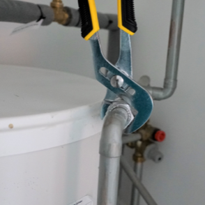 Pipe wrench fastening bolt onto small pipe